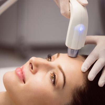 Female patient receiving cosmetic treatment at clinic